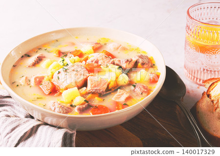 a bowl of soup on a light background, Finnish fish soup, lohikeito soup, creamy fish soup, a bowl of soup on a light background, Finnish fish soup, lohikeito soup, creamy fish soup, 140017329