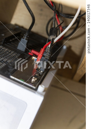 Messy Computer Cables and Internet Network Wires Connected to PC Back Panel Messy Computer Cables and Internet Network Wires Connected to PC Back Panel 140017346