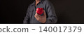 Man hand holding red heart shape on dark background. Concept of love, healthcare, medical insurance and charity donation. Valentine's day symbol for romantic relationship and kindness support. 140017379