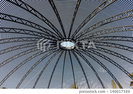 Metallic garden gazebo ceiling with a circular web design. Metallic garden gazebo ceiling with a circular web design. 140017389