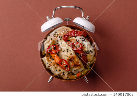 Gyoza, Chinese or Japanese meat dumplings, is an Asian food with hot peppers. Gyoza with meat Gyoza, Chinese or Japanese meat dumplings, is an Asian food with hot peppers. Gyoza with meat 140017802