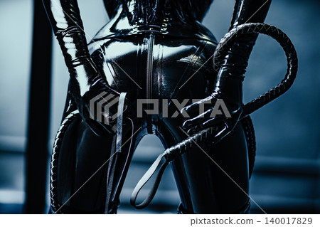 Bdsm style woman in black latex with whip Bdsm style woman in black latex with whip 140017829