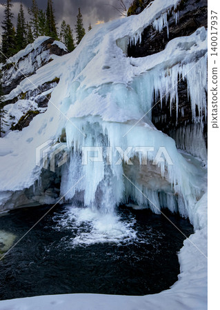 Frozen Mountain Waterfalls in Serene Winter Landscape Frozen Mountain Waterfalls in Serene Winter Landscape 140017937