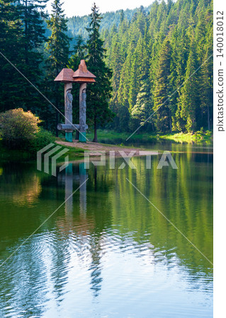 landscape with mountain lake of synevyr national park. green carpathian nature scenery in summer. coniferous forest reflection on the water. popular travel destination of ukraine in the afternoon 140018012