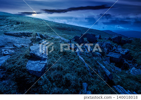 alpine grassy meadow at night. full moon over carpathian mountains landscape with huge boulders. alpine nature scenery of ukraine highlands in summer. mysterious view of remote place in mountains alpine grassy meadow at night. full moon over carpathian mountains landscape with huge boulders. alpine nature scenery of ukraine highlands in summer. mysterious view of remote place in mountains 140018018