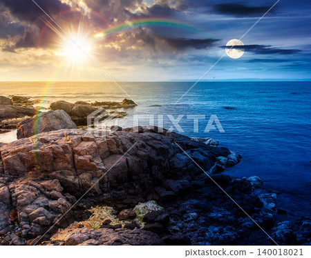 sea coast with stones and rocks. day meet night. summer vacation background at twilight. sun and moon in harmony over seascape with rough terrain. relaxing at the sea. coast of bulgaria wallpaper sea coast with stones and rocks. day meet night. summer vacation background at twilight. sun and moon in harmony over seascape with rough terrain. relaxing at the sea. coast of bulgaria wallpaper 140018021
