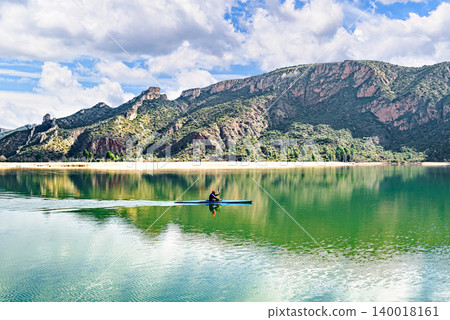 Man kayaking on the reservoir in the Sant Llorenc de Montgai Natural Park, Noguera region, Lleida, Catalonia. Nature, water sports Man kayaking on the reservoir in the Sant Llorenc de Montgai Natural Park, Noguera region, Lleida, Catalonia. Nature, water sports 140018161