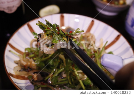 Chopsticks Picking Up Fresh Seafood Salad Chopsticks Picking Up Fresh Seafood Salad 140018223