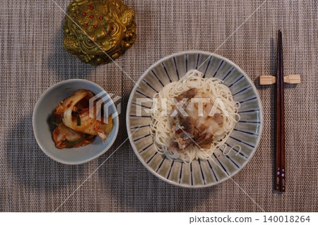 Noodle Bowl with Side Dish and Chopsticks on Textured Table Noodle Bowl with Side Dish and Chopsticks on Textured Table 140018264