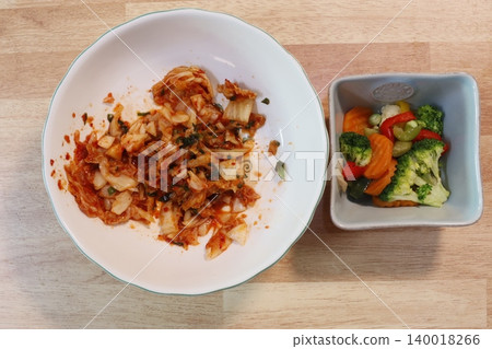 Kimchi and Vegetable Meal on Wooden Surface Kimchi and Vegetable Meal on Wooden Surface 140018266