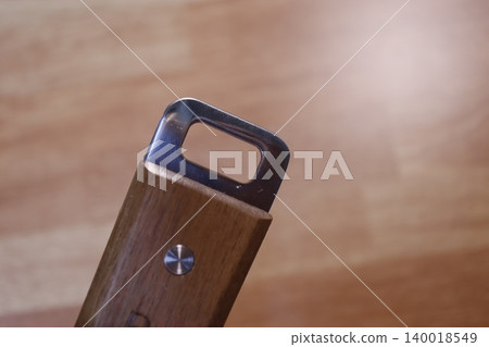 Close-up of Tool Handle with Wooden Grip and Metal Loop Close-up of Tool Handle with Wooden Grip and Metal Loop 140018549