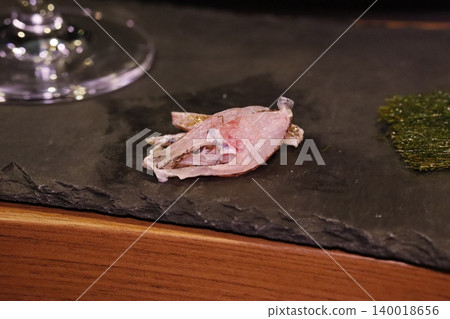 Sliced Raw Fish on Slate Plate with Garnish 140018656