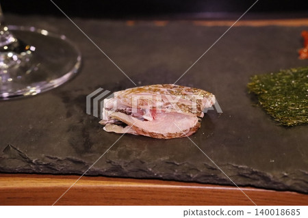 Sliced Fish on Slate Plate with Garnish 140018685