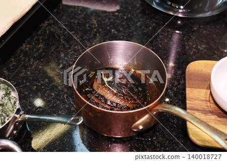 Caramelized Onions in Copper Pot on Stovetop 140018727