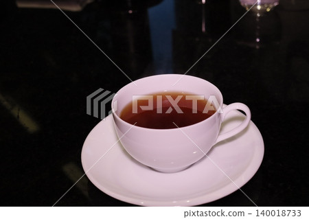 Steaming Cup of Tea on Saucer 140018733