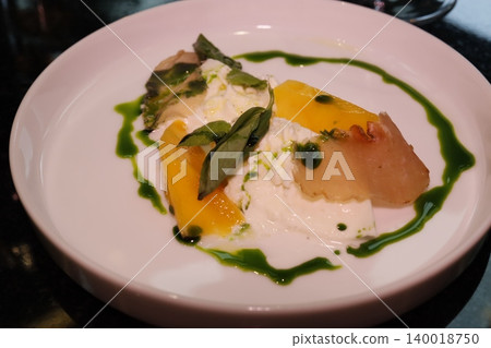 Elegant Plate of Artisanal Dish with Citrus and Basil 140018750