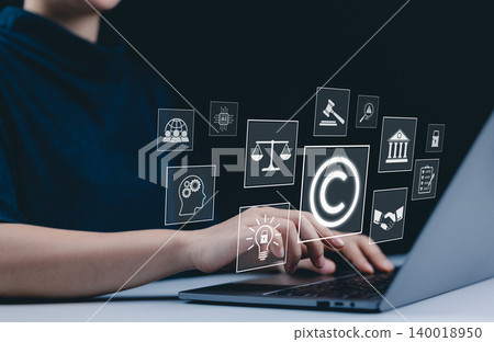Copyright and intellectual property protection concept. A person use laptop with icons copyright, intellectual property, legal balance scales, patents, technology law, digital rights, and protection. Copyright and intellectual property protection concept. A person use laptop with icons copyright, intellectual property, legal balance scales, patents, technology law, digital rights, and protection. 140018950
