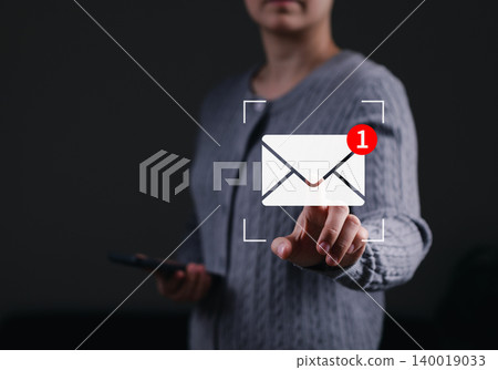 Email marketing concept. Woman touching digital envelope icon showing new message notification badge representing corporate newsletter communication, online contact, mobile mail, inbox reminder, Email marketing concept. Woman touching digital envelope icon showing new message notification badge representing corporate newsletter communication, online contact, mobile mail, inbox reminder, 140019033