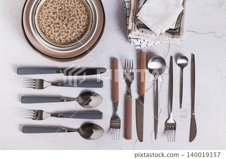 A set of cutlery, plates and napkins on the table top view A set of cutlery, plates and napkins on the table top view 140019157