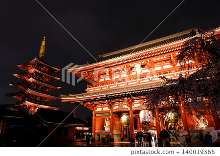 東京淺草寺寶藏門和五重塔在春雨綿綿的夜晚燈火通明,夜晚的櫻花也映入眼簾。 東京淺草寺寶藏門和五重塔在春雨綿綿的夜晚燈火通明,夜晚的櫻花也映入眼簾。 140019368