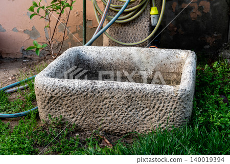 rustic garden stone container near garden tap in garden rustic garden stone container near garden tap in garden 140019394