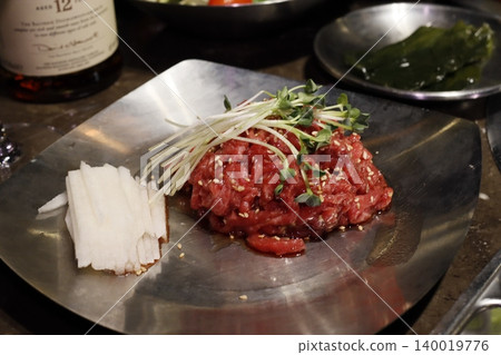 Raw Beef Dish with Sesame and Garnishes Raw Beef Dish with Sesame and Garnishes 140019776