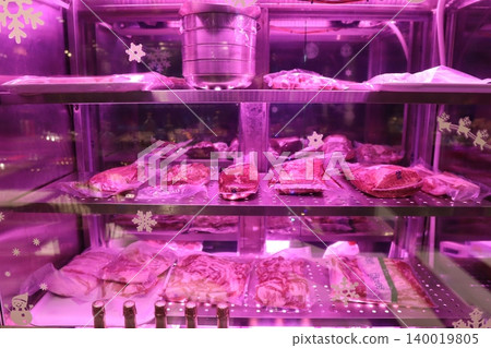 Purple-Lit Meat Display Case with Snowflake Decorations Purple-Lit Meat Display Case with Snowflake Decorations 140019805