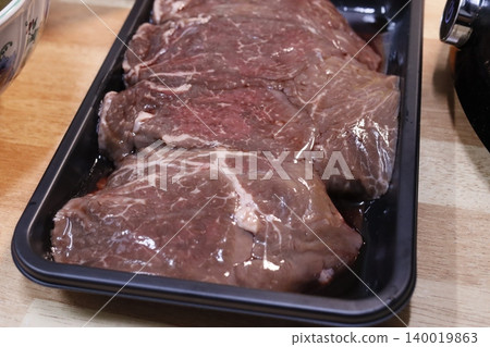 Raw Steaks in Tray on Wooden Surface Raw Steaks in Tray on Wooden Surface 140019863