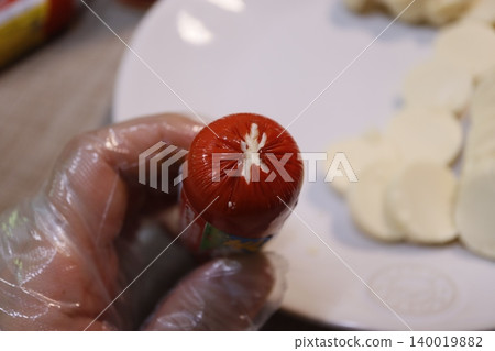 Hand Holding Sausage with Sliced Cheese Hand Holding Sausage with Sliced Cheese 140019882