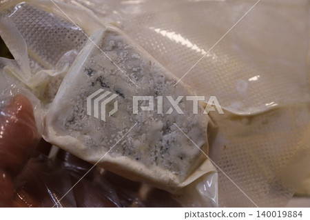 Blue Cheese with Mold in Plastic Wrap Blue Cheese with Mold in Plastic Wrap 140019884