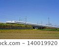 The Tokaido Shinkansen N700A runs through a sunny rural landscape. 140019920