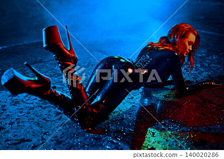 Bdsm style woman in black latex posing in aqua studio 140020286