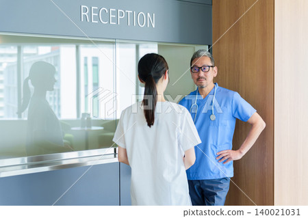 Doctors and nurses having a meeting 140021031