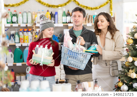 Portrait of family with full shopping basket in supermarket before christmas Portrait of family with full shopping basket in supermarket before christmas 140021725