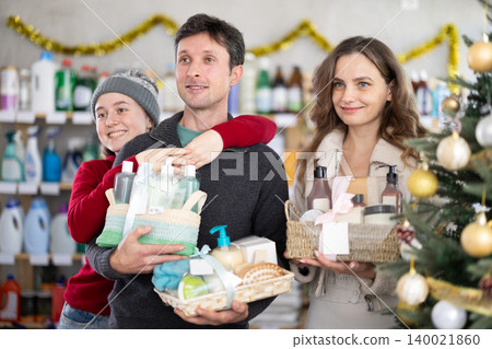Cheerful family choosing self-care gift sets in Christmas decorated store Cheerful family choosing self-care gift sets in Christmas decorated store 140021860