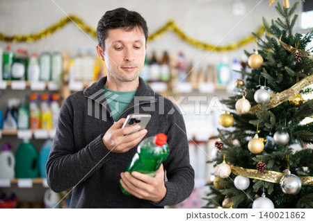 Male client choose and scanning QR code on package dishwashing gel Male client choose and scanning QR code on package dishwashing gel 140021862