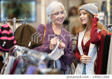 Elderly and young women choosing hat Elderly and young women choosing hat 140021886