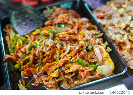 Marinated beef with vegetables ready for stir-fry on supermarket display Marinated beef with vegetables ready for stir-fry on supermarket display 140022043