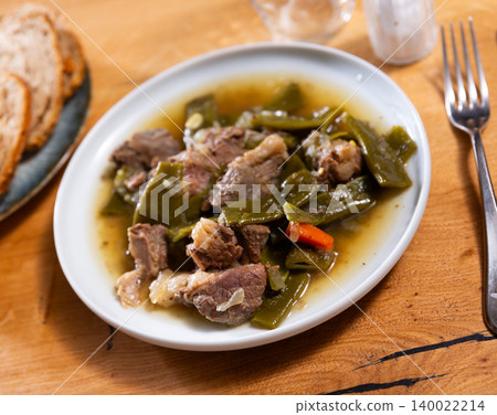 Beef stew served with green beans Beef stew served with green beans 140022214