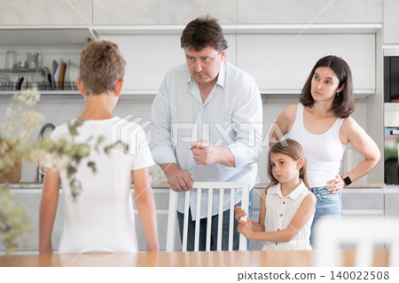 Father and mother telling off son and daughter for disobedience Father and mother telling off son and daughter for disobedience 140022508