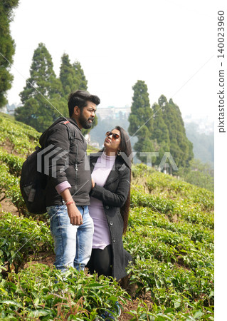 Young Couple Enjoying Romantic Vacation Together In A Scenic Tea Garden Landscape Young Couple Enjoying Romantic Vacation Together In A Scenic Tea Garden Landscape 140023960