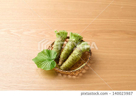 Fresh wasabi served in a basket 140023987