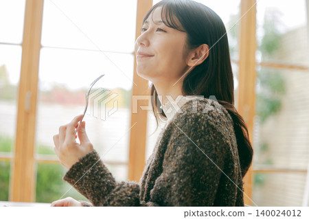 A woman living alone enjoys making her own breakfast. A woman living alone enjoys making her own breakfast. 140024012
