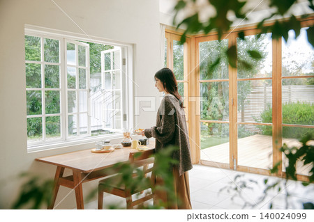 A woman enjoying cooking 140024099