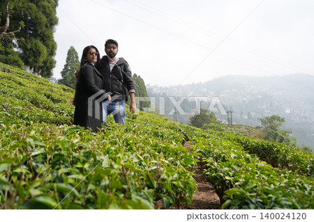 Happy Couple Posing For A Portrait Amidst The Lush Green Tea Garden at Darjeeling 140024120