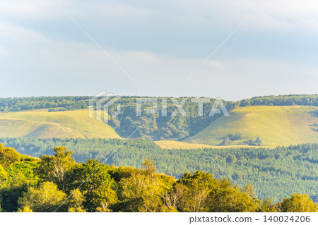 Layers of green mountains and hills in the haze during sunset. Panoramic View of Green hills and Meadow. Layers of green mountains and hills in the haze during sunset. Panoramic View of Green hills and Meadow. 140024206