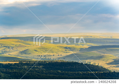 Layers of green mountains and hills in the haze during sunset. Panoramic View of Green hills and Meadow. Layers of green mountains and hills in the haze during sunset. Panoramic View of Green hills and Meadow. 140024208