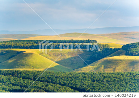 Layers of green mountains and hills in the haze during sunset. Panoramic View of Green hills and Meadow. Layers of green mountains and hills in the haze during sunset. Panoramic View of Green hills and Meadow. 140024219