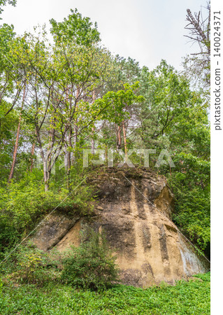 Majestic rocky cliffs and towering pine trees against blue sky. Majestic rocky cliffs and towering pine trees against blue sky. 140024371