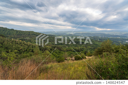Layers of green mountains and hills in the haze during sunset. Panoramic View of Green hills and Meadow. Layers of green mountains and hills in the haze during sunset. Panoramic View of Green hills and Meadow. 140024547